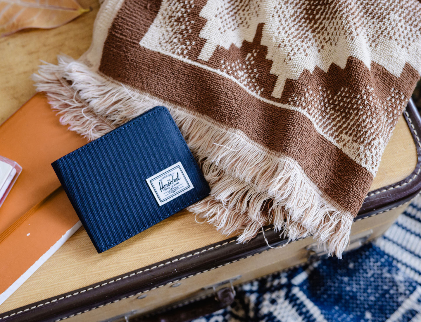 Herschel Supply Co. Roy Coin Wallet in navy blue, showcasing its classic bifold design and functional coin pocket.
