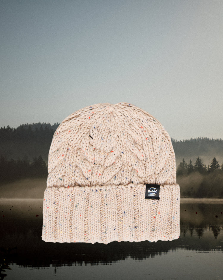 Herschel Supply Co. Ellis Cable Beanie in Vintage White Marled, showing a close-up of the knit pattern and folded cuff.
