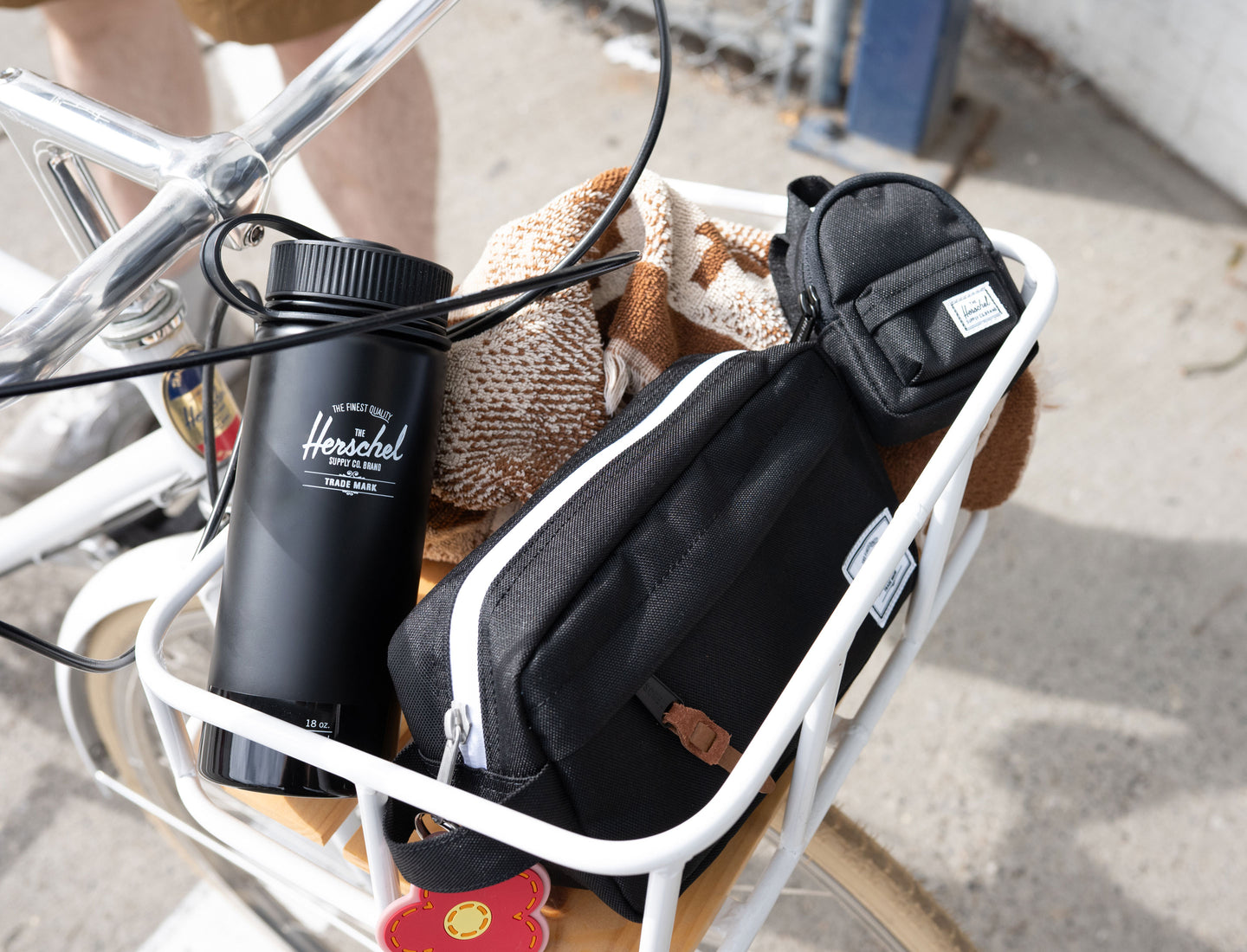 Herschel Supply Co. insulated 18oz water bottle in a sleek black gloss finish, shown in a clean desktop studio shot.