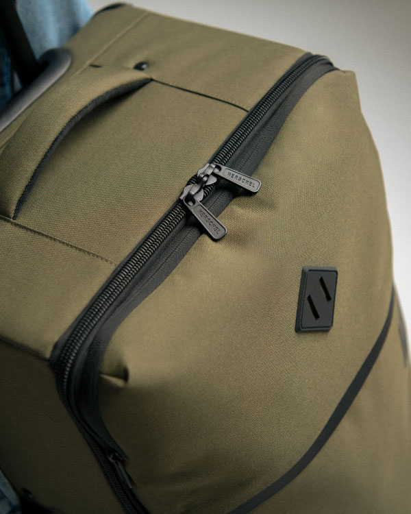 An Ivy Green Highland Luggage from above showing the zippered main compartment and signature Herschel Supply Co. diamond